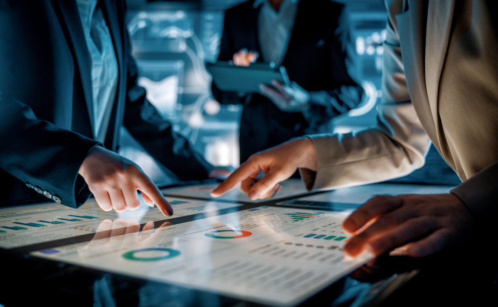 Business Team Collaborating On Interactive Touchscreen Table In Futuristic Office
